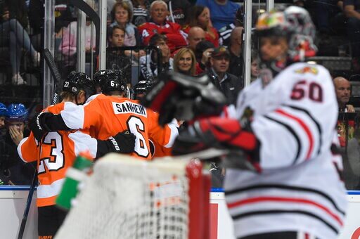 Flyers players celebrate the first goal