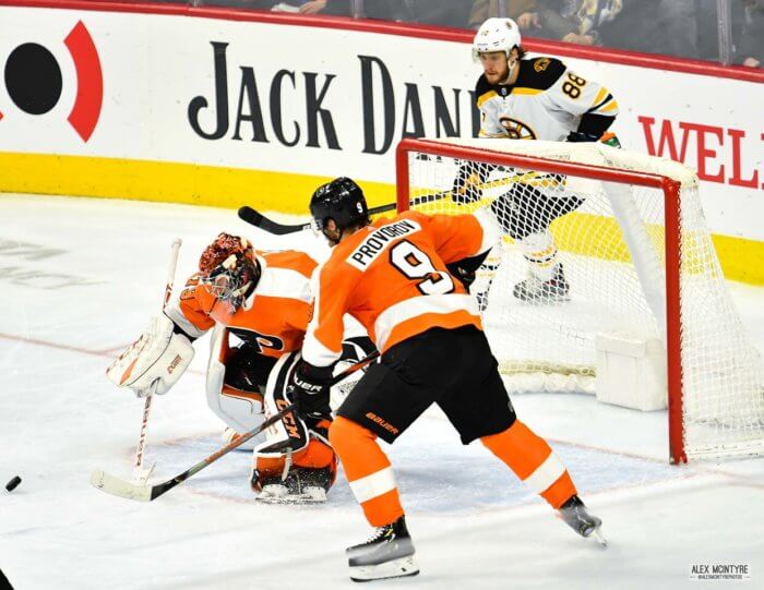 Carter Hart and Ivan Provorov gather the puck versus the Boston Bruins