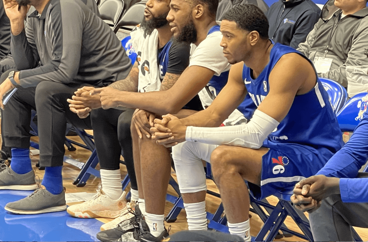 Shaq Harrison watches pensively courtside as the Blue Coats face the Cleveland Charge