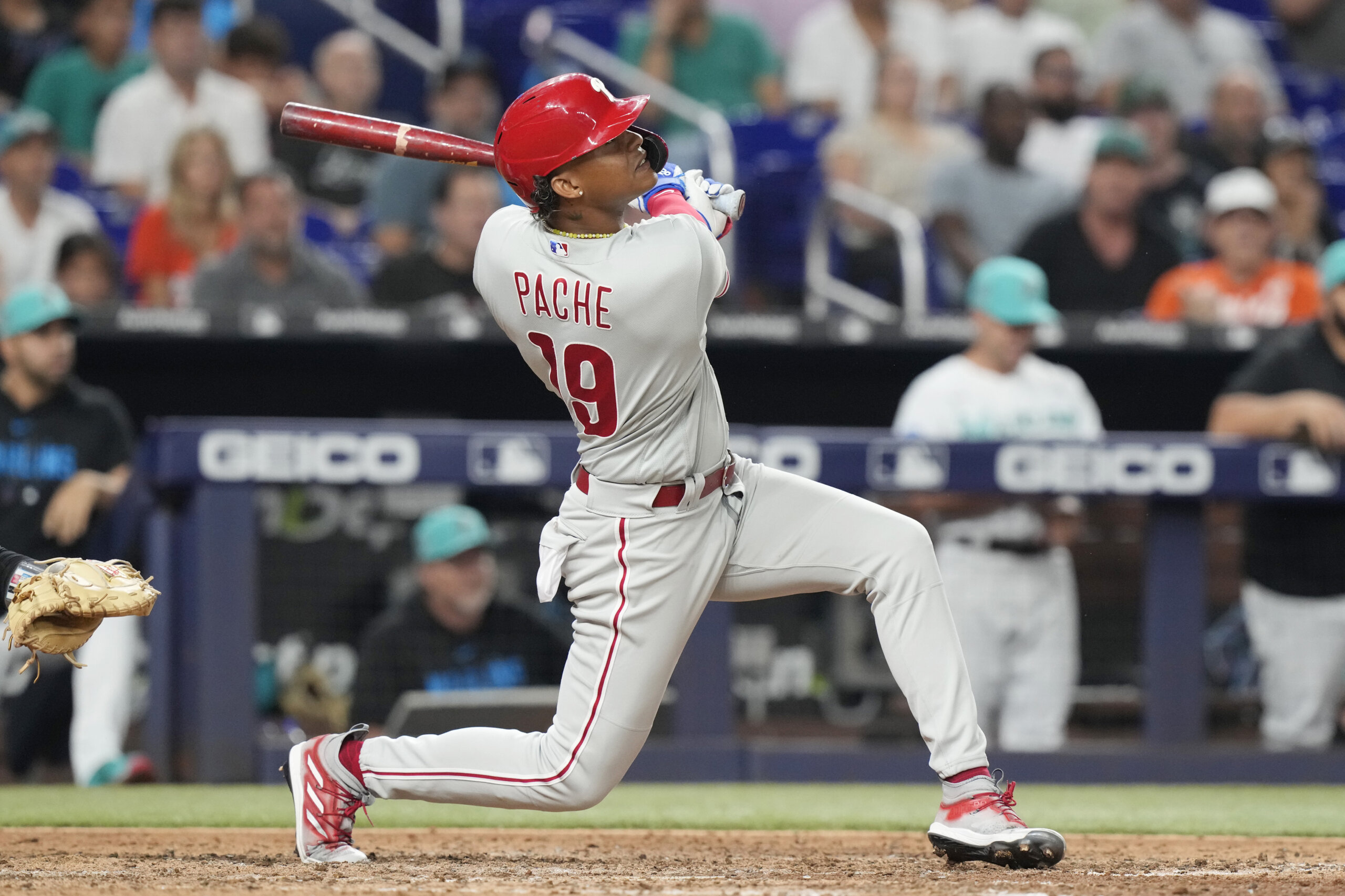 Miami Marlins' Jean Segura runs to beat the throw by Philadelphia Phillies  second baseman Bryson Stott but is out at the plate during the eighth  inning of a baseball game, Sunday, July